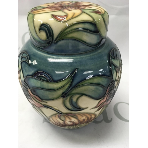 1004 - A Moorcroft ginger jar and cover decorated with Lily's. 16 cm .