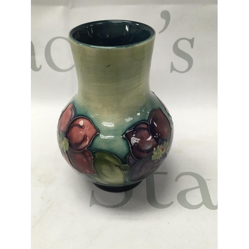 1005 - A Small Moorcroft Vase decorated with flowers and foliage.13 cm .