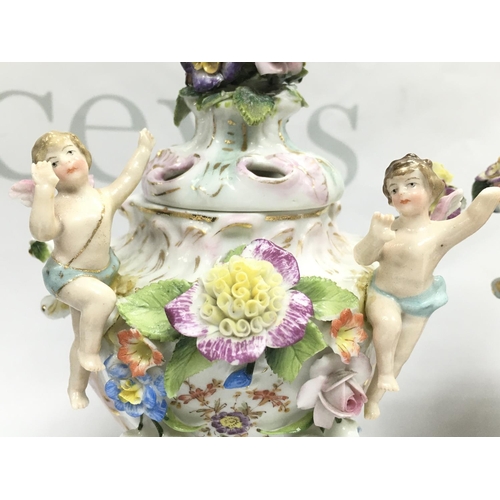 1026 - A pair of Chelsea porcelain Potpourri vases , some damage . 21cm tall approximately. This lot cannot... 