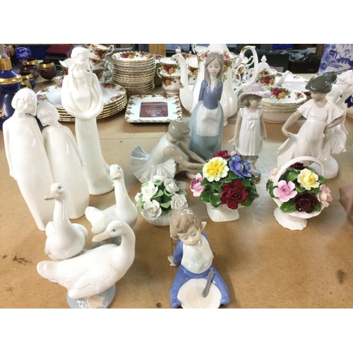 1086 - A collection of assorted ceramic figurines including NAO royal Doulton etc.