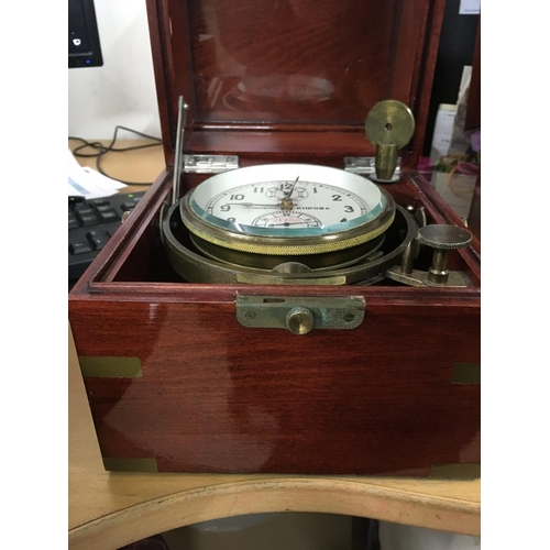 1338 - A Russian marine ships chronometer desk clock fitted in a mahogany brass Bound case .