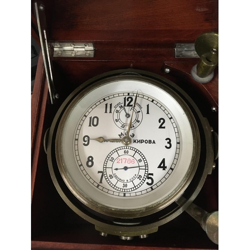 1338 - A Russian marine ships chronometer desk clock fitted in a mahogany brass Bound case .