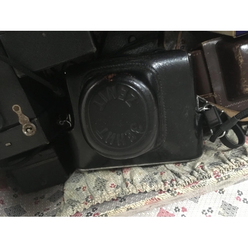 2308 - A case containing vintage camera equipment