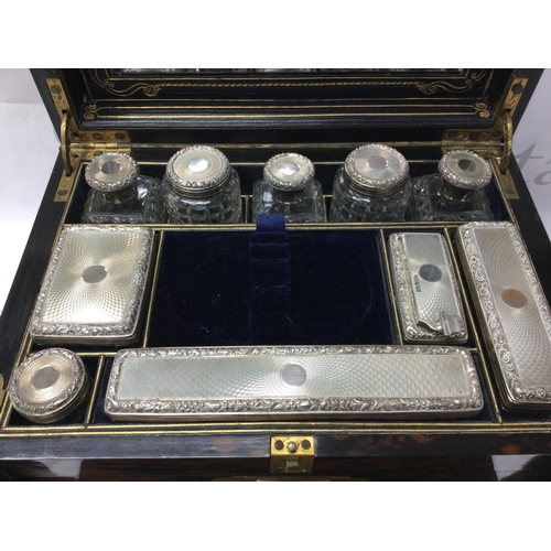 766 - A coromandel traveling vanity case with hinged cover containing a number of silver dressing table ja... 