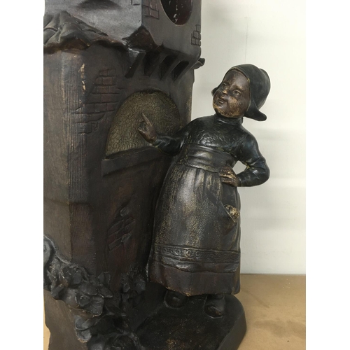 769 - Plaster watch/clock holder with Dutch girl and birds decoration 55cm tall. This lot cannot be posted