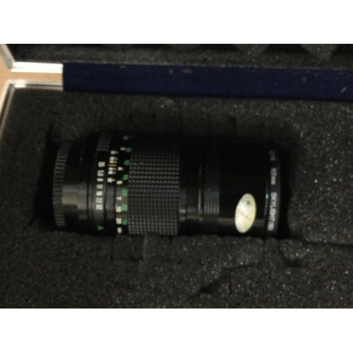 775 - A cased cannon camera with flash and lens.