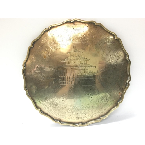 863 - A Japanese brass tray with Pagoda design, dimensions 40x40cm .postage category C. NO RESERVE