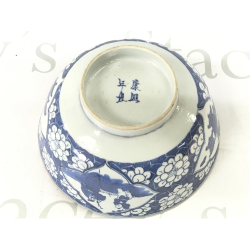 874 - A 19th century Chinese blue and white bowl with a four character mark at the base, 18cm wide. Hairli... 