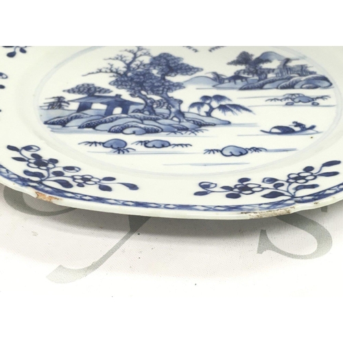 877 - An 18th century Chinese octagonal blue and white plate decorated with a river scene , 23cm wide. Chi... 