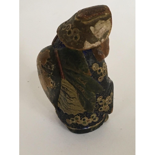 904 - A small 19th Japanese hand painted figure of an elder 6.5cm high.