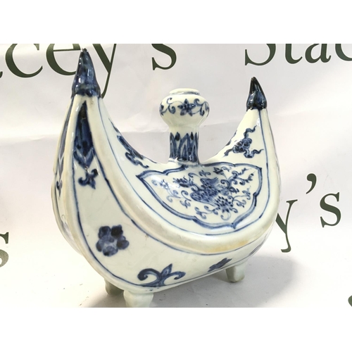 920 - A Chinese Islamic blue and white porcelain four footed candle holder, hand painted crescent shaped p... 