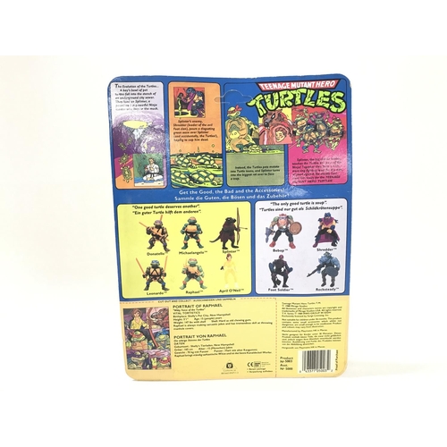 220 - A Carded Playmates Teenage Mutant Hero Turtles Raphael Figure. Blister has Some Damage. Un punched.