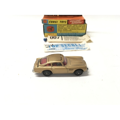 24 - A boxed 261 Corgi James Bond 007 gold coloured Aston Martin DB5. Includes 2x ejector passengers and ... 