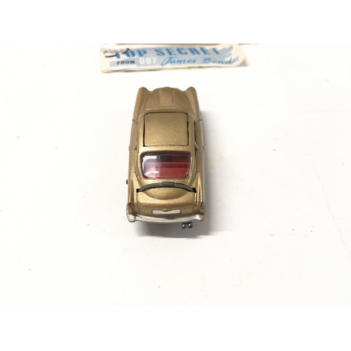 24 - A boxed 261 Corgi James Bond 007 gold coloured Aston Martin DB5. Includes 2x ejector passengers and ... 