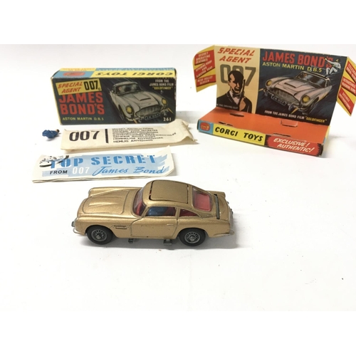 24 - A boxed 261 Corgi James Bond 007 gold coloured Aston Martin DB5. Includes 2x ejector passengers and ... 