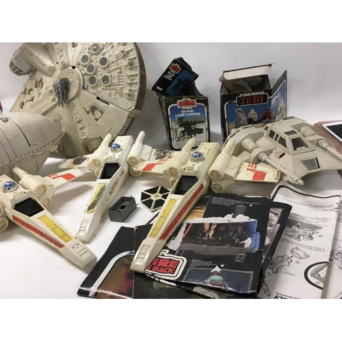 261 - A collection of Vintage Star Wars ships and mini rigs. Also includes leaflet and comic.