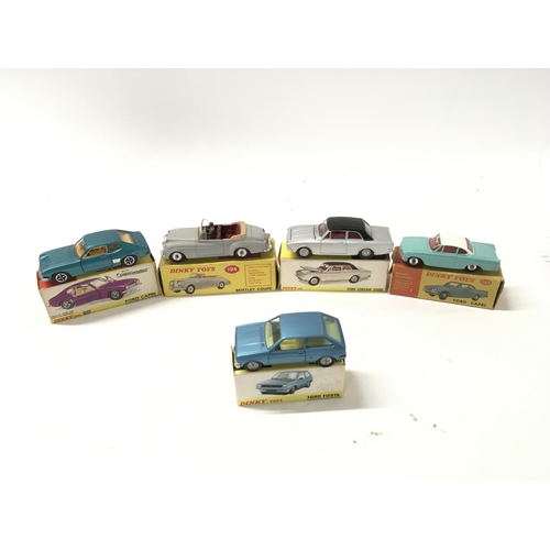 27 - A collection of of 5 boxed diecast model cars by Dinky includes No. 143 a Ford Capri.. No.165 a Ford... 