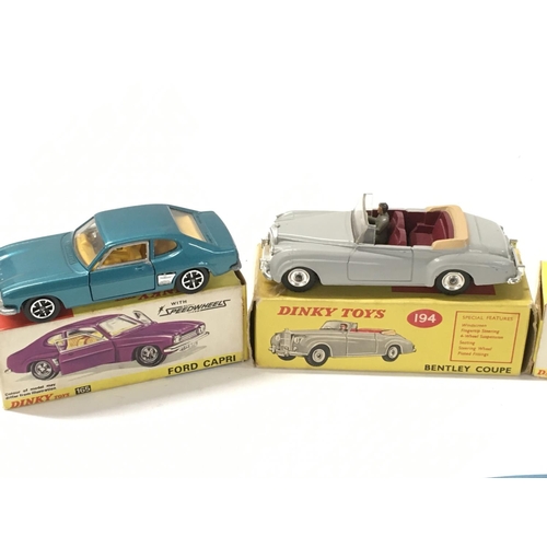 27 - A collection of of 5 boxed diecast model cars by Dinky includes No. 143 a Ford Capri.. No.165 a Ford... 