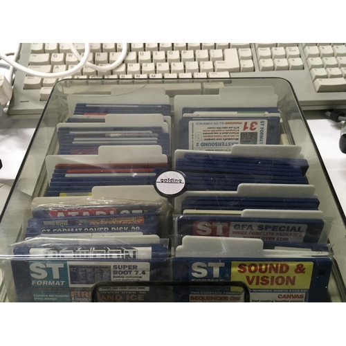 335 - An Atari ST COMPUTER and accessories including floppy disk drive etc. includes two plastic disk stor... 