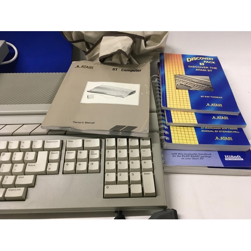 335 - An Atari ST COMPUTER and accessories including floppy disk drive etc. includes two plastic disk stor... 