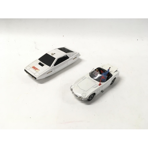 34 - A collection of 5 loose diecast model cars by Dinky and Corgi includes 2 007 themed cars.