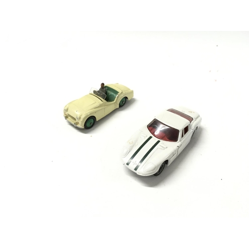 34 - A collection of 5 loose diecast model cars by Dinky and Corgi includes 2 007 themed cars.