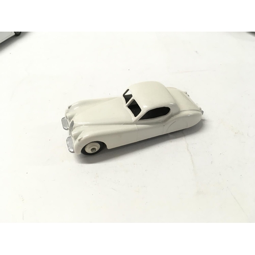 34 - A collection of 5 loose diecast model cars by Dinky and Corgi includes 2 007 themed cars.