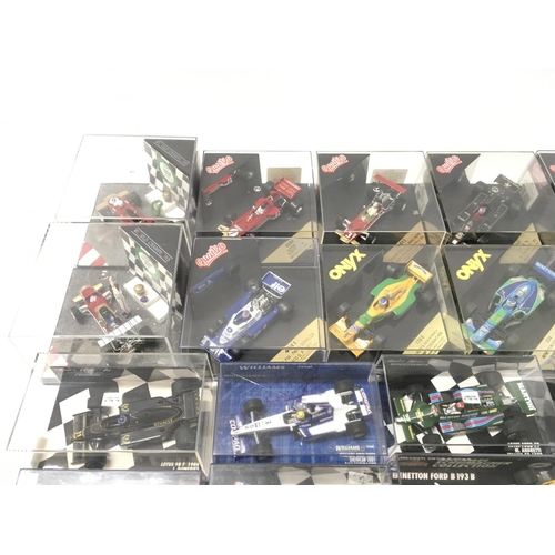 35 - A collection of 19 model F1 racing call all in display boxes.