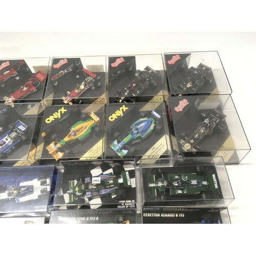 35 - A collection of 19 model F1 racing call all in display boxes.