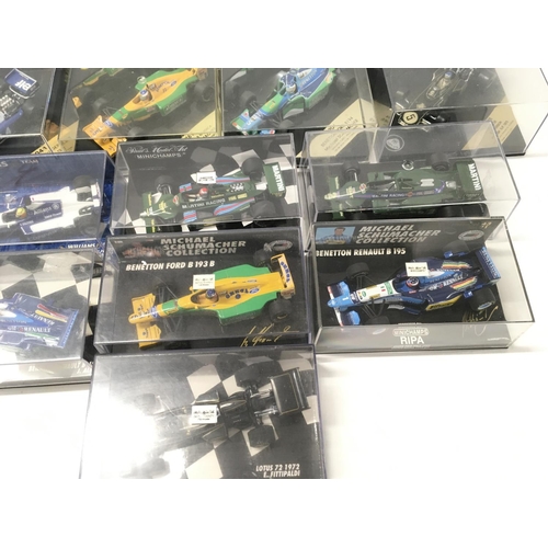 35 - A collection of 19 model F1 racing call all in display boxes.