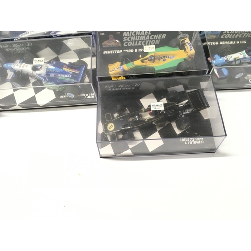 35 - A collection of 19 model F1 racing call all in display boxes.