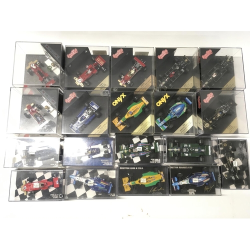 35 - A collection of 19 model F1 racing call all in display boxes.