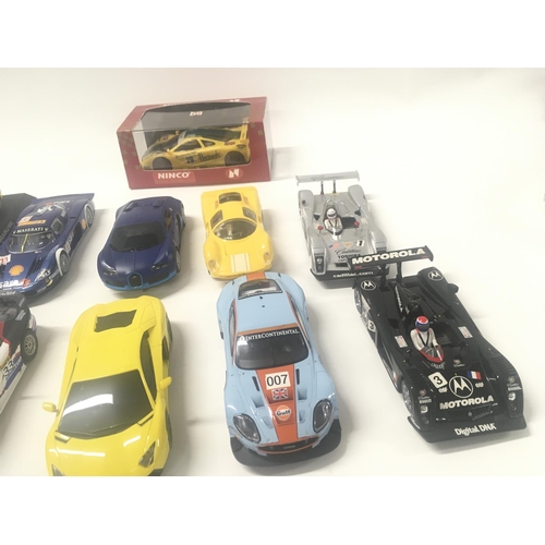 523 - A collection of 10 Scalextric cars and 1 boxed Ninco car.