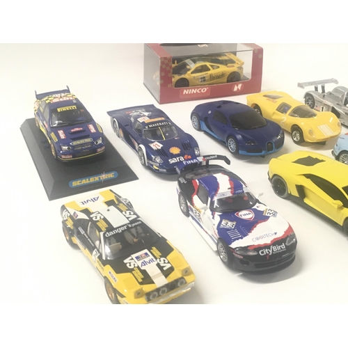 523 - A collection of 10 Scalextric cars and 1 boxed Ninco car.