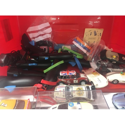 524 - A box containing in excess of 12 Scalextric cars plus accessories and approximately 10 hand controll... 