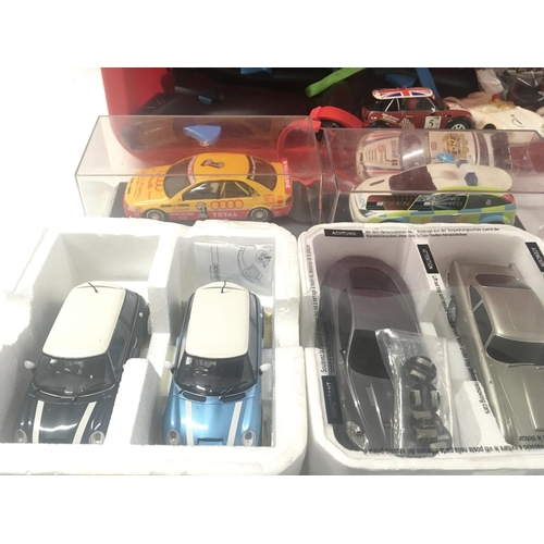 524 - A box containing in excess of 12 Scalextric cars plus accessories and approximately 10 hand controll... 