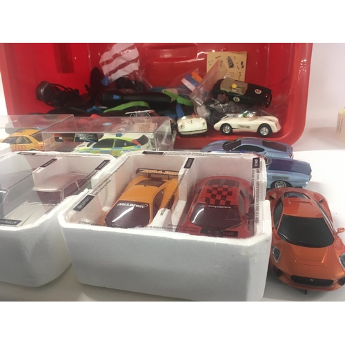 524 - A box containing in excess of 12 Scalextric cars plus accessories and approximately 10 hand controll... 