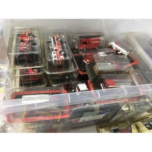 587 - Large collection of boxed model diecast models including a large number of model fire engines etc. N... 