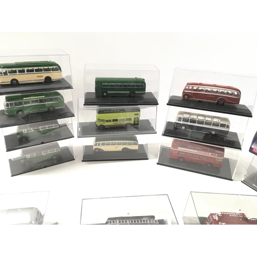 690 - A collection of 19 diecast model vehicles in display boxes featuring buses..fire engines..tanker etc... 