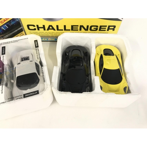 700 - A box containing 6 Scalextric cars. As well as a Digital Lap counter. A safety car challenger. No re... 