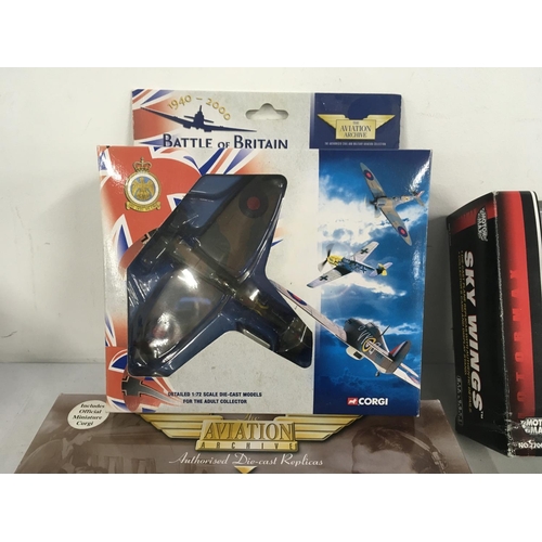 81 - A collection of four model aircraft in original display packaging by Corgi..MotorMax and Maisto. Inc... 