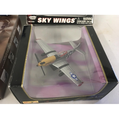 81 - A collection of four model aircraft in original display packaging by Corgi..MotorMax and Maisto. Inc... 