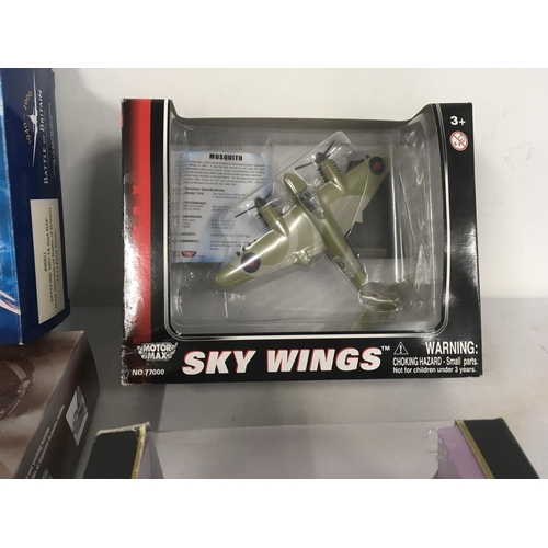 81 - A collection of four model aircraft in original display packaging by Corgi..MotorMax and Maisto. Inc... 