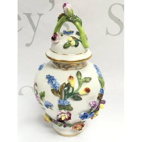 1005 - A Dresden urn & cover, hand painted with a figural scene and floral decoration . 19cm tall. This lot... 