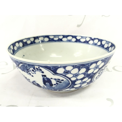 859 - A 19th century Chinese blue and white bowl decorated with figures and cherry blossom. Four character... 