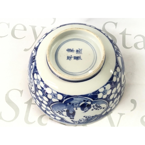 859 - A 19th century Chinese blue and white bowl decorated with figures and cherry blossom. Four character... 
