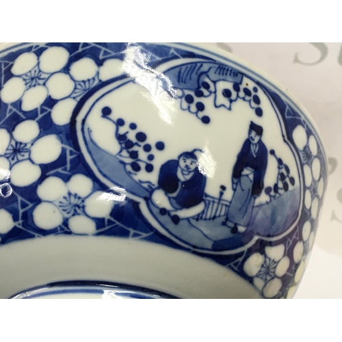 859 - A 19th century Chinese blue and white bowl decorated with figures and cherry blossom. Four character... 