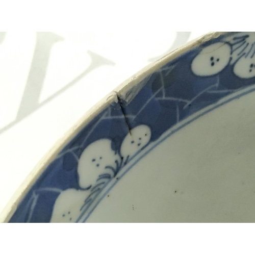 860 - A 19th century Chinese blue and white bowl with a four character mark at the base, 18cm wide. Hairli... 