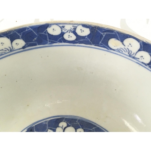 860 - A 19th century Chinese blue and white bowl with a four character mark at the base, 18cm wide. Hairli... 
