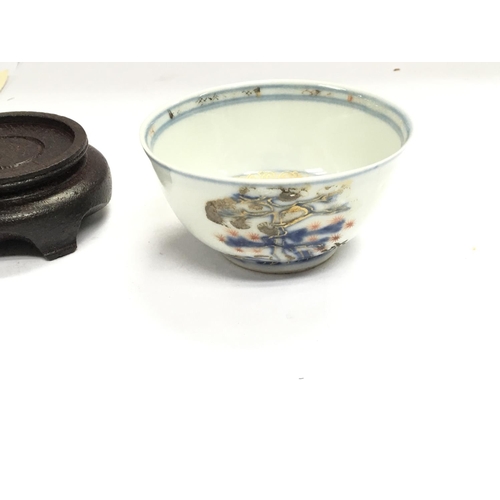 872 - An Imari bamboo and pine tea bowl raised from the wreck of the Geldermalsen with COA.